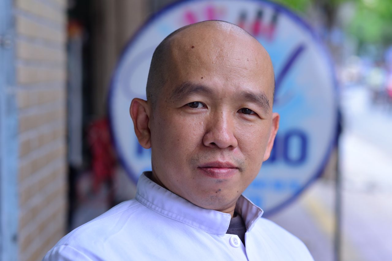 Home Close-up portrait of a confident adult man standing outdoors wearing a white shirt.